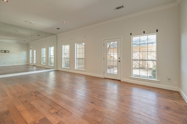 unfurnished room featuring plenty of natural light and light wood-type flooring