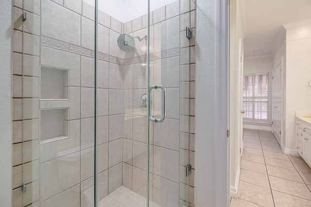 bathroom featuring tile patterned floors, crown molding, vanity, and an enclosed shower