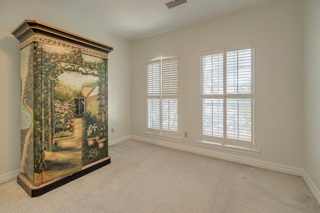 spare room with light colored carpet