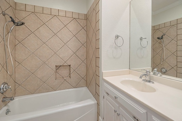 bathroom with tiled shower / bath combo, ornamental molding, and vanity