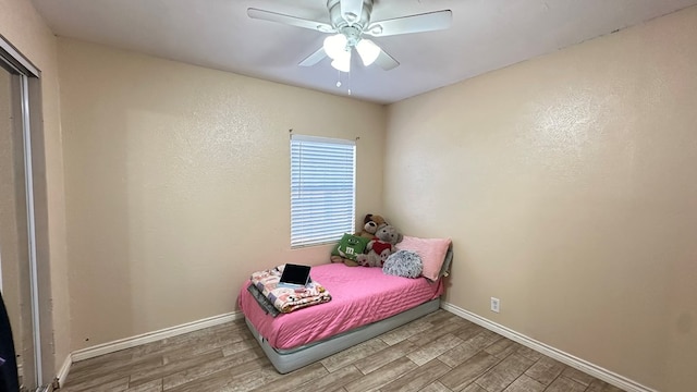 bedroom with hardwood / wood-style flooring and ceiling fan