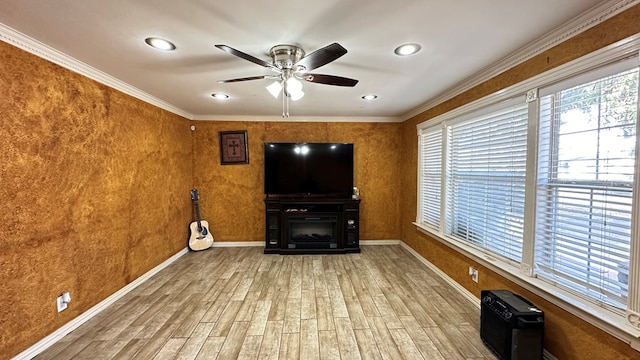 unfurnished living room with ceiling fan, ornamental molding, and hardwood / wood-style flooring