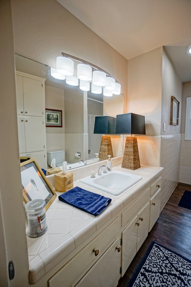 bathroom featuring hardwood / wood-style flooring, vanity, and toilet