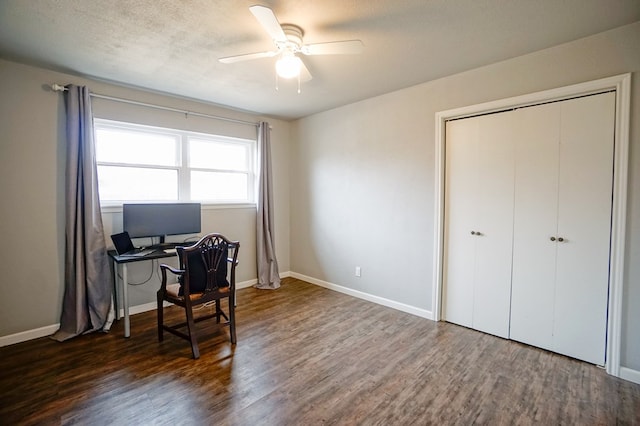 office space featuring ceiling fan, dark hardwood / wood-style floors, and a textured ceiling