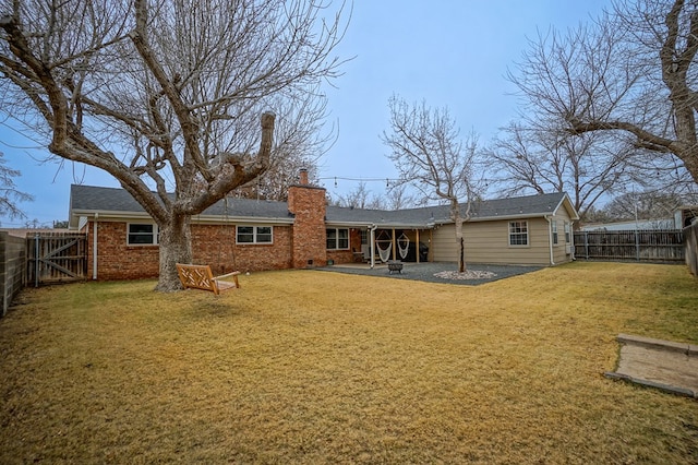 rear view of house with a yard and a patio area