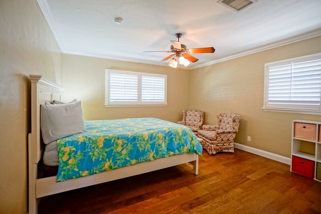 bedroom with multiple windows, hardwood / wood-style flooring, ceiling fan, and ornamental molding