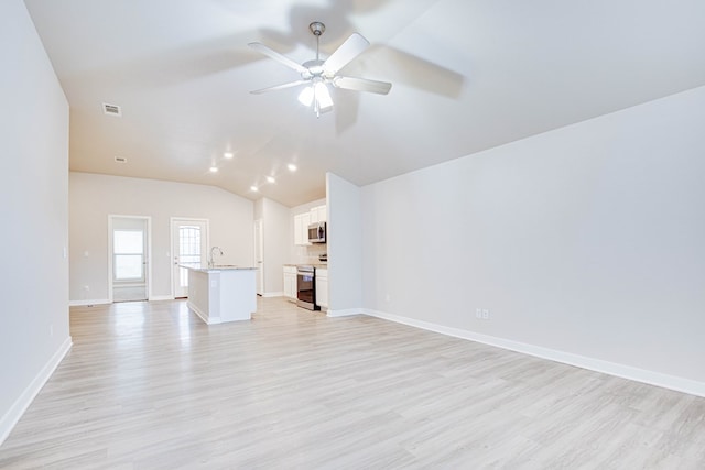 307 Pioneer Cir, Midland, TX 79705 - unfurnished living room featuring light wood finished floors, a ceiling fan, and vaulted ceiling