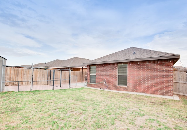 307 Pioneer Cir, Midland, TX 79705 - back of property featuring brick siding, a fenced backyard, a shingled roof, and a patio