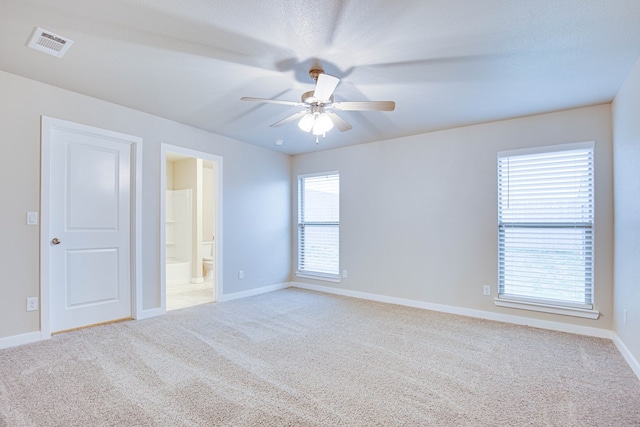 307 Pioneer Cir, Midland, TX 79705 - unfurnished bedroom with carpet, ensuite bathroom, and a ceiling fan