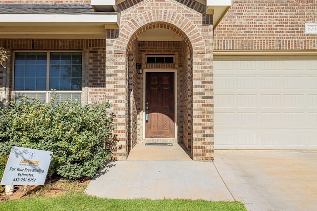 view of exterior entry with a garage