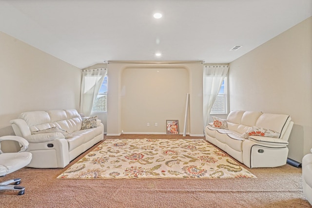 living room featuring carpet flooring, plenty of natural light, and lofted ceiling