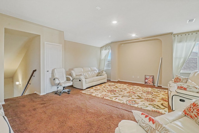 carpeted living room featuring lofted ceiling