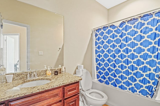 full bathroom with vanity, shower / bath combo, and toilet