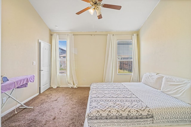 carpeted bedroom with vaulted ceiling and ceiling fan