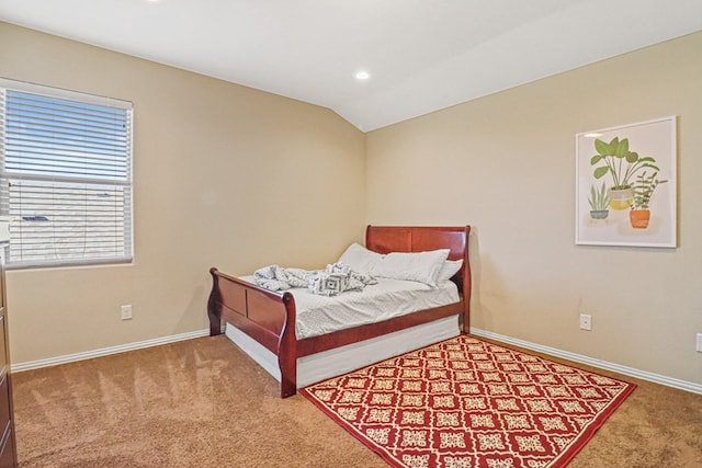 bedroom with carpet and lofted ceiling