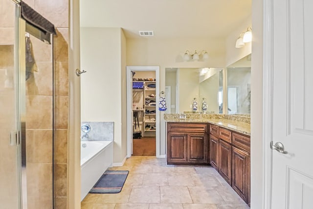 bathroom featuring vanity and separate shower and tub