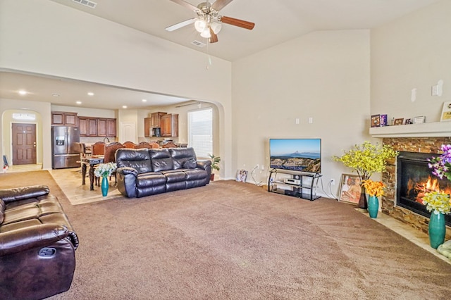 carpeted living room featuring ceiling fan and lofted ceiling