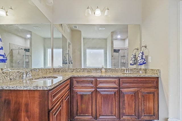 bathroom featuring vanity and a shower with shower door