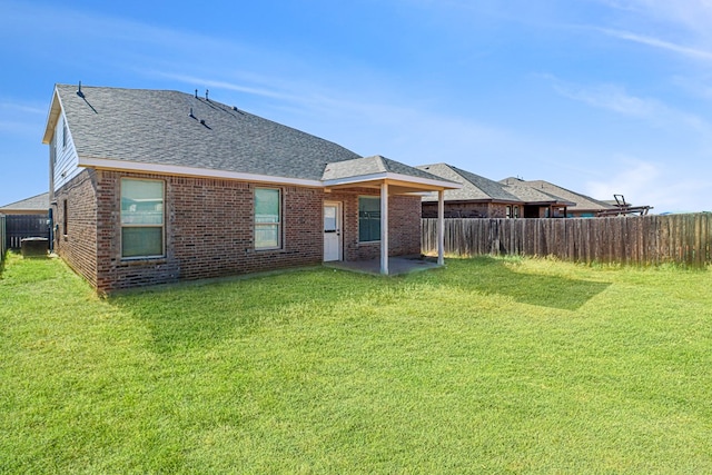 rear view of property with a lawn