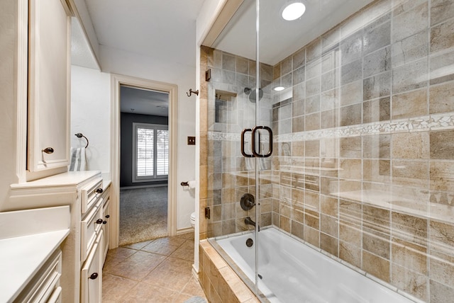 full bathroom with tile patterned flooring, vanity, shower / bath combination with glass door, and toilet