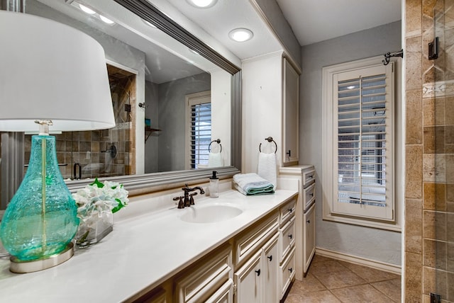 bathroom featuring vanity, a shower with door, and tile patterned flooring