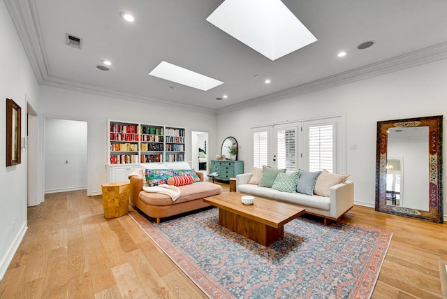 living room featuring light hardwood / wood-style flooring, crown molding, and a skylight