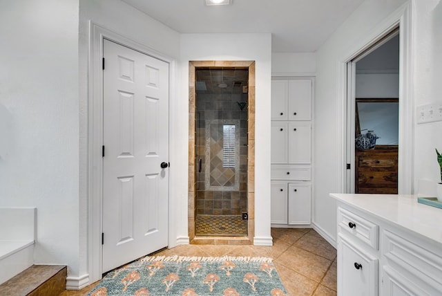 bathroom featuring walk in shower, vanity, and tile patterned flooring