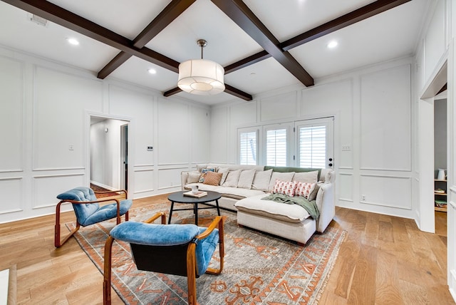 living room with coffered ceiling, light hardwood / wood-style floors, and beamed ceiling