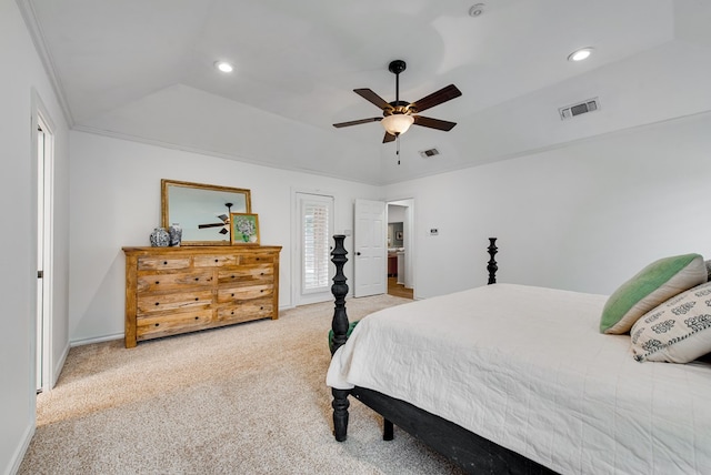 carpeted bedroom with a raised ceiling, vaulted ceiling, and ceiling fan