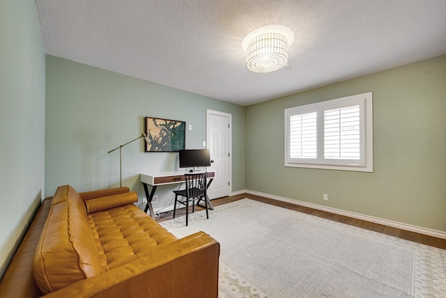 office area with hardwood / wood-style flooring and a textured ceiling