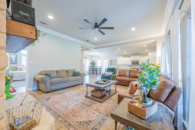 living area featuring ornamental molding, a ceiling fan, recessed lighting, and light wood-style floors