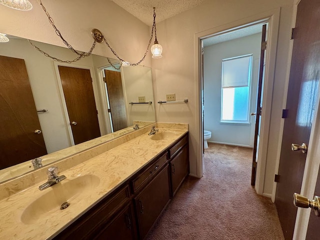 bathroom featuring vanity, a textured ceiling, toilet, and lofted ceiling