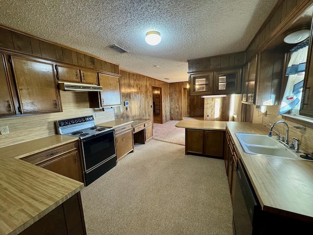 kitchen featuring dishwasher, sink, electric range, light colored carpet, and kitchen peninsula