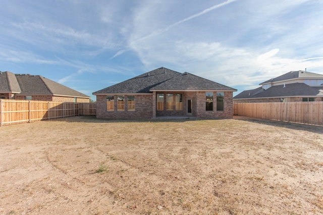 back of property featuring a lawn