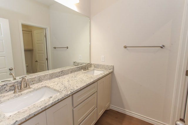 bathroom with vanity, hardwood / wood-style floors, and toilet