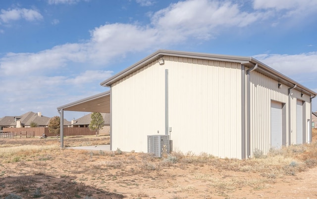 view of home's exterior featuring central AC unit and a garage