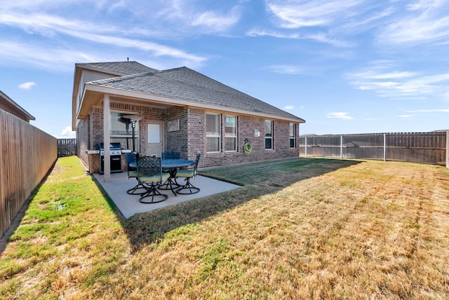 back of house featuring a yard and a patio