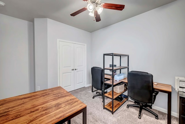 office space with light colored carpet and ceiling fan