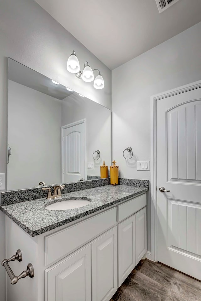 bathroom featuring hardwood / wood-style flooring and vanity