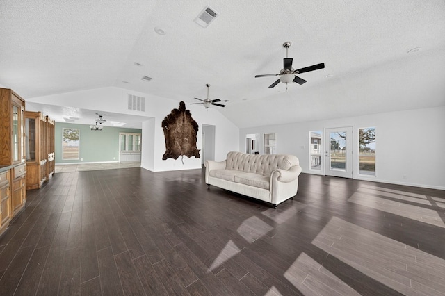 4715 N County Rd 1125, Midland, TX 79705 - living area featuring lofted ceiling, dark wood-style flooring, ceiling fan, a chandelier, and a textured ceiling