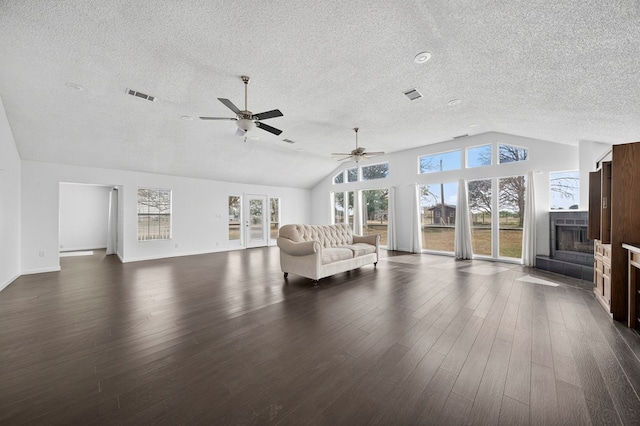 4715 N County Rd 1125, Midland, TX 79705 - living area with a textured ceiling, lofted ceiling, a ceiling fan, dark wood-type flooring, and a fireplace