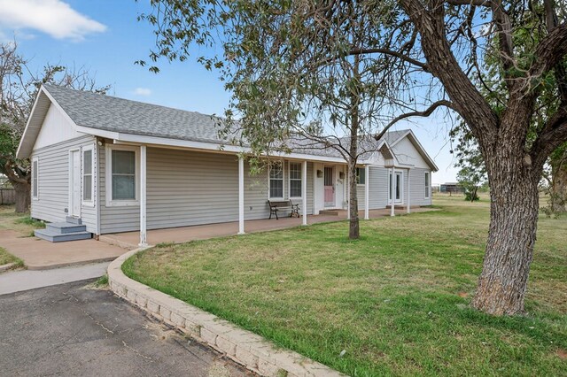 4715 N County Rd 1125, Midland, TX 79705 - single story home featuring a shingled roof and a front lawn