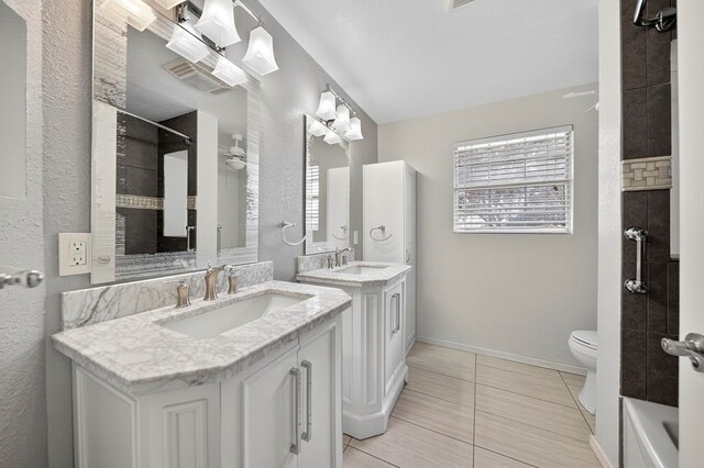 4715 N County Rd 1125, Midland, TX 79705 - full bath with ceiling fan, two vanities, a shower, tile patterned flooring, and a tub to relax in