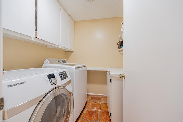 washroom with cabinets and washing machine and dryer