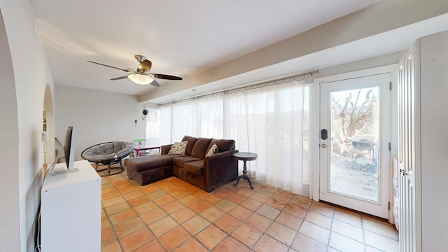 tiled living room with ceiling fan