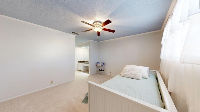 carpeted bedroom featuring crown molding, connected bathroom, ceiling fan, and a textured ceiling