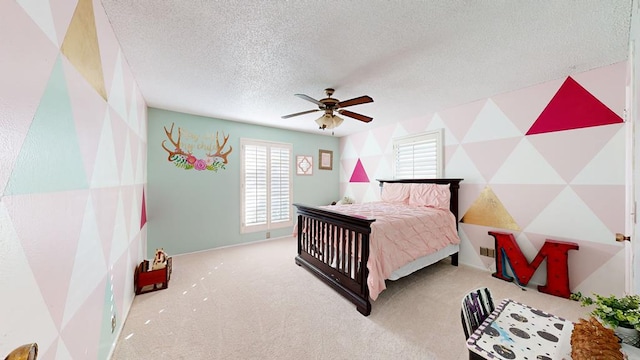 bedroom with ceiling fan, light colored carpet, and a textured ceiling