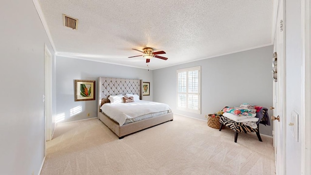 bedroom featuring light carpet, ceiling fan, crown molding, and a textured ceiling