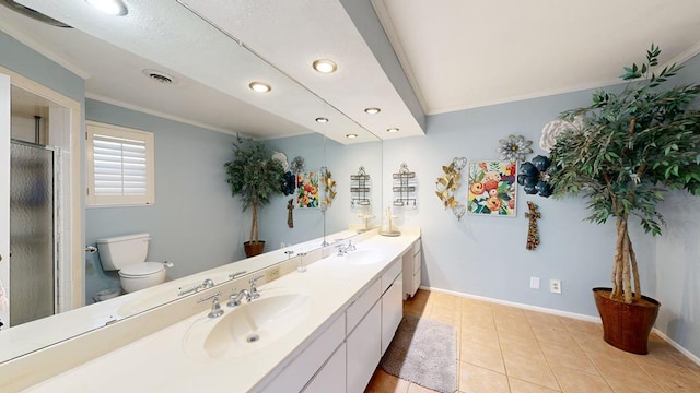 bathroom featuring tile patterned flooring, ornamental molding, vanity, an enclosed shower, and toilet