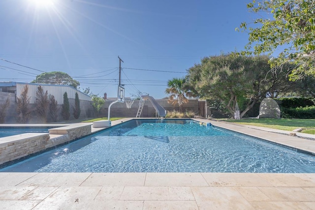1703 Laurel Ave, Odessa, TX 79761 - view of pool featuring a water slide, a fenced backyard, and an in-ground hot tub